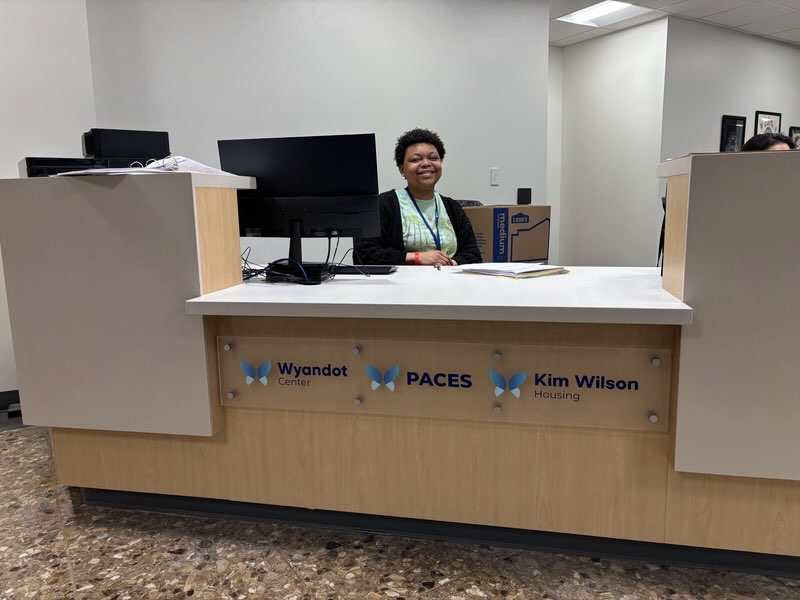Photo of smiling customer care representative in lobby of Wyandot BHN Downtown Wellness Center
