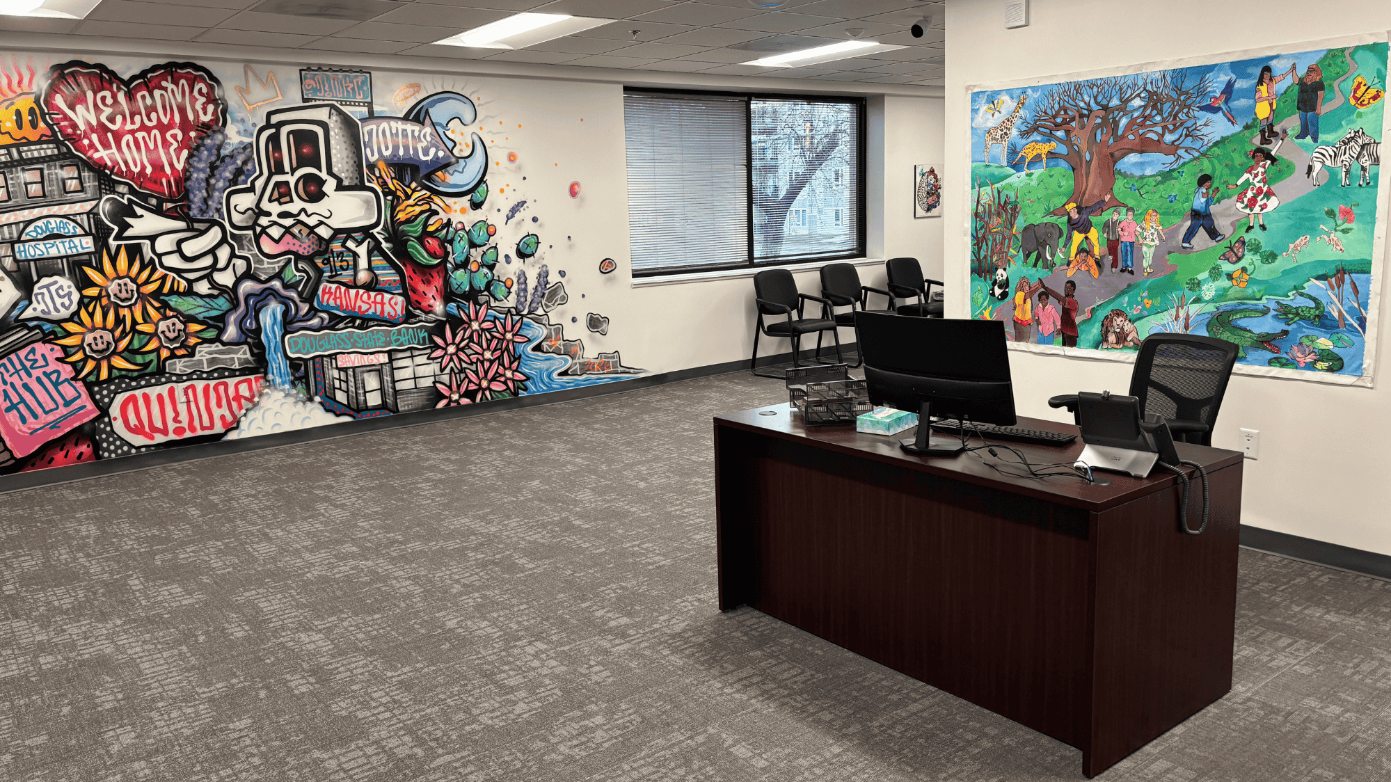 Lobby of Wyandot BHN Downtown Wellness center with artwork on walls and care coordinator desk
