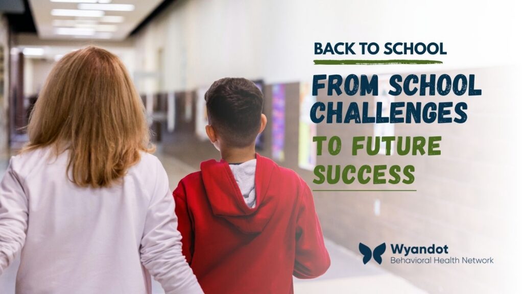 Student walking through a school hallway with a backpack